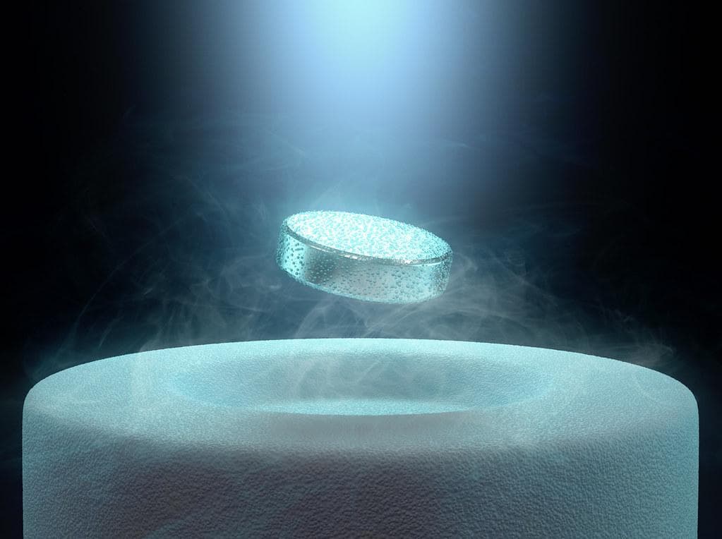 A superconducting material levitating over a magnet.